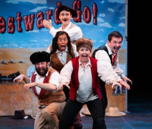 Westward Go! performance photo. Cast mid-performance depicting shock and excitement while on their adventure.