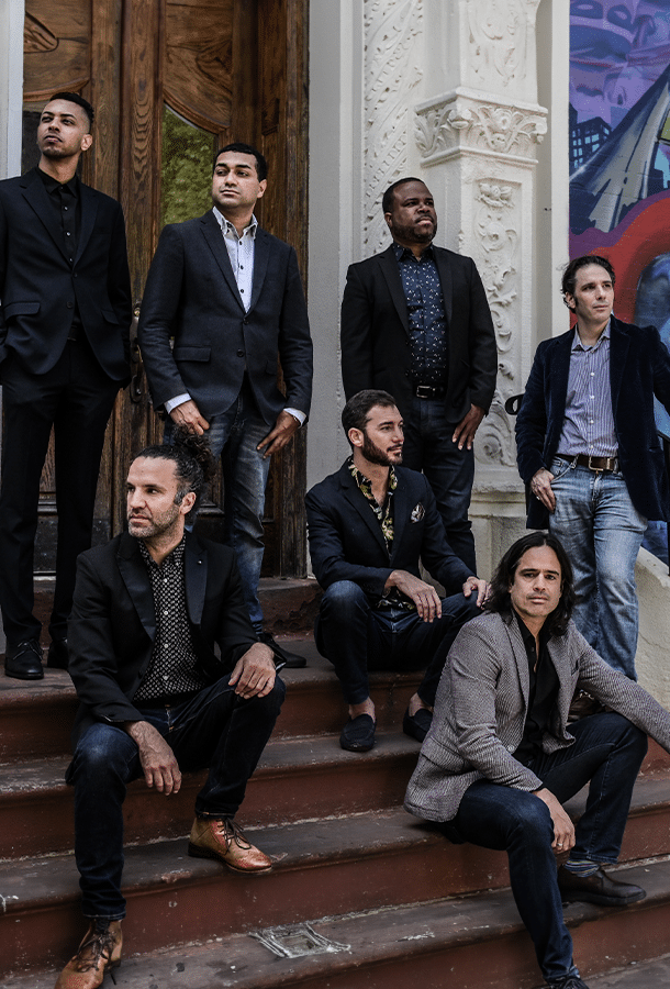 Los Hacheros full band photo shoot on outside porch steps