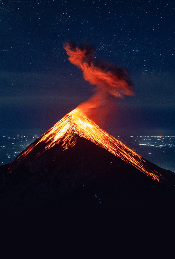 volcano erupting at night