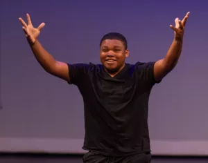 Young man reciting Shakespeare and gesturing broadly with his hands