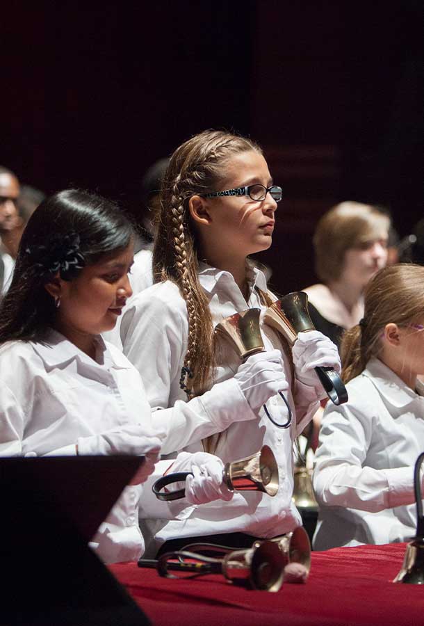 students playing handbells