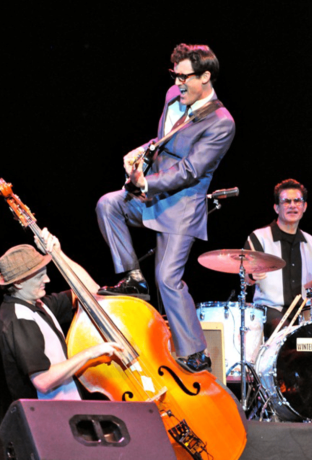 man jamming away with band members