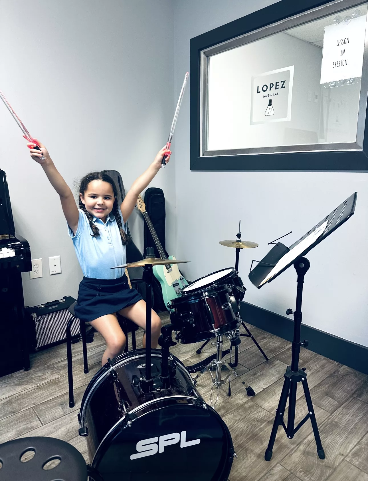 girl siting behind drums