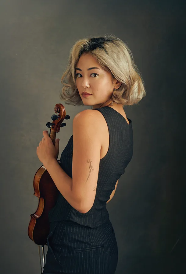 Simone Porter posing with her violin.