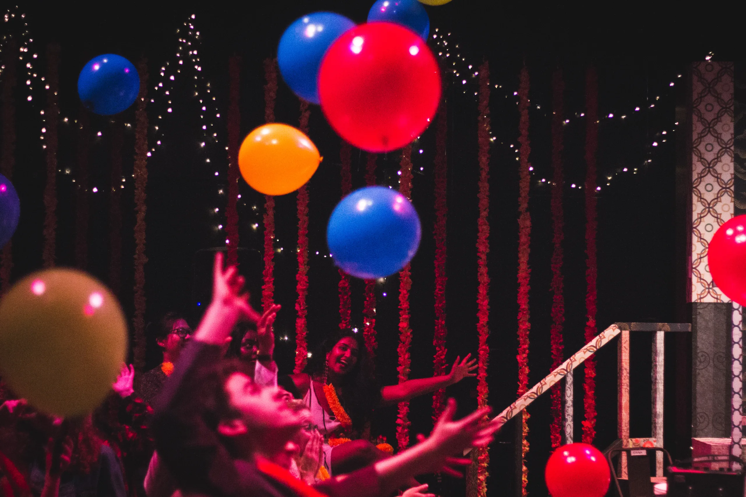 Red, blue and yellow balloons in the air floating. Photo Credit Ankita Singh