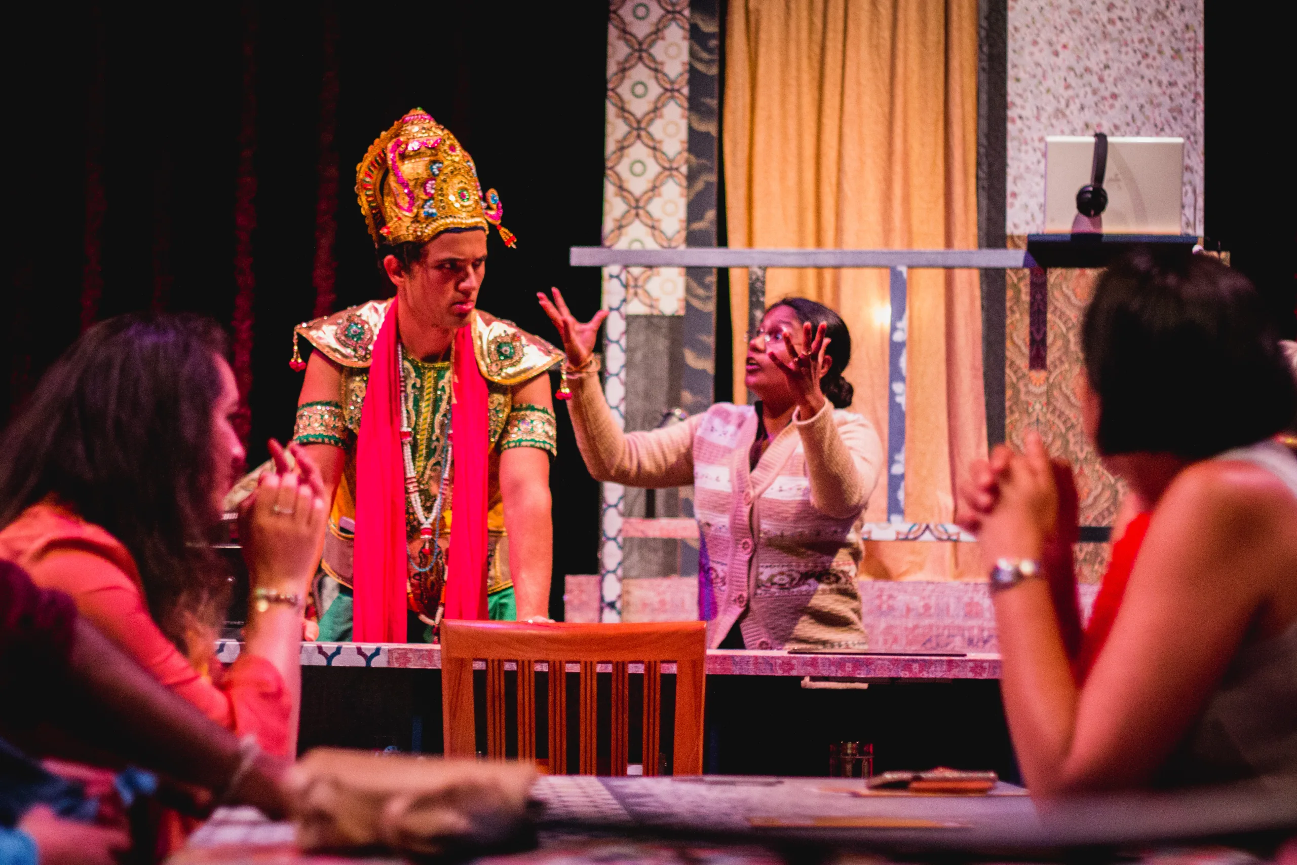 man in Indian hat and women on stage. Photo Credit Ankita Singh