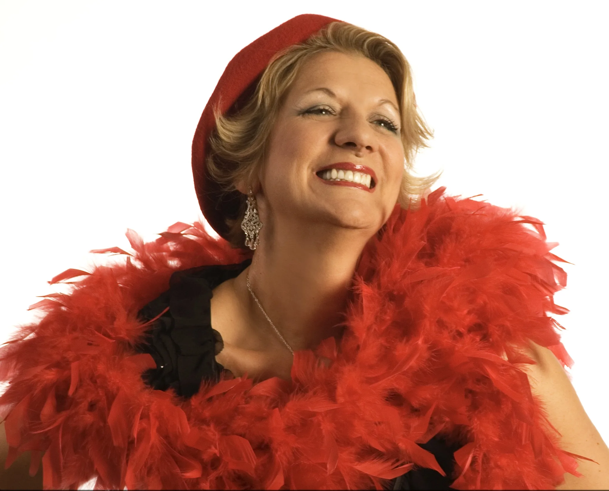 Annie Royer as Piaf poses for camera with red boa